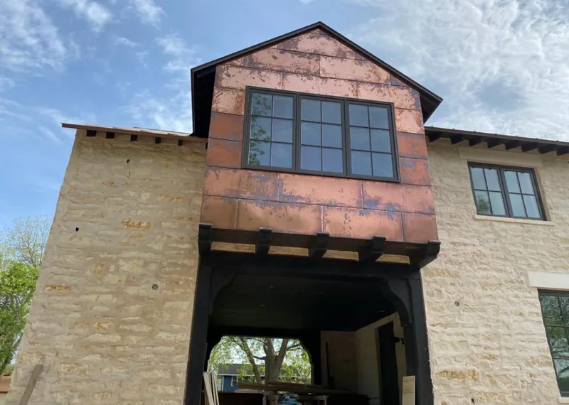 Copper metal panel facade on a stone building for Roof Repair in Frederick